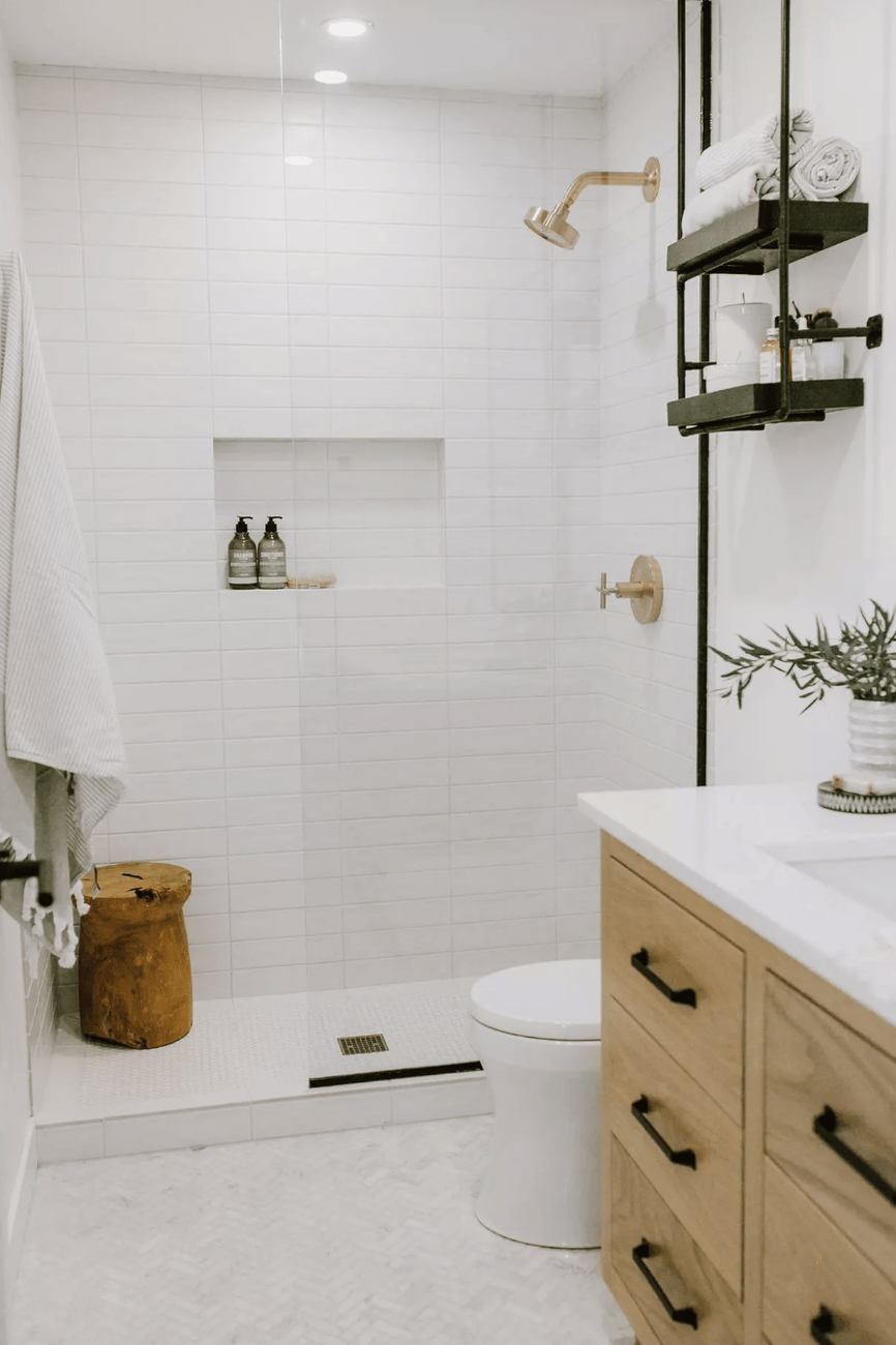 basement farmhouse bathroom with pot lights glass shower wood vanity white countertop open shelving