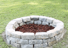 stone fire pit in grass