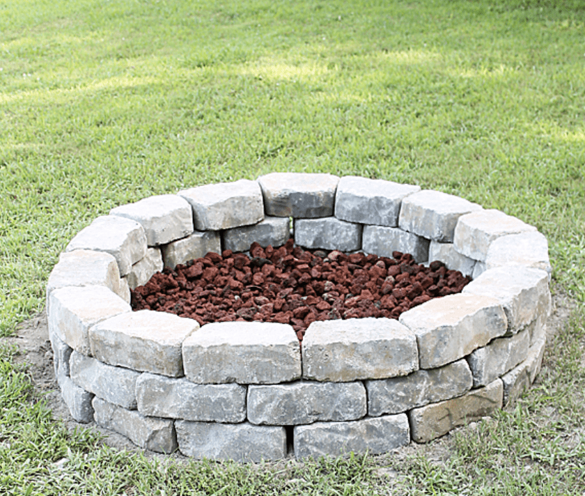 stone fire pit in grass