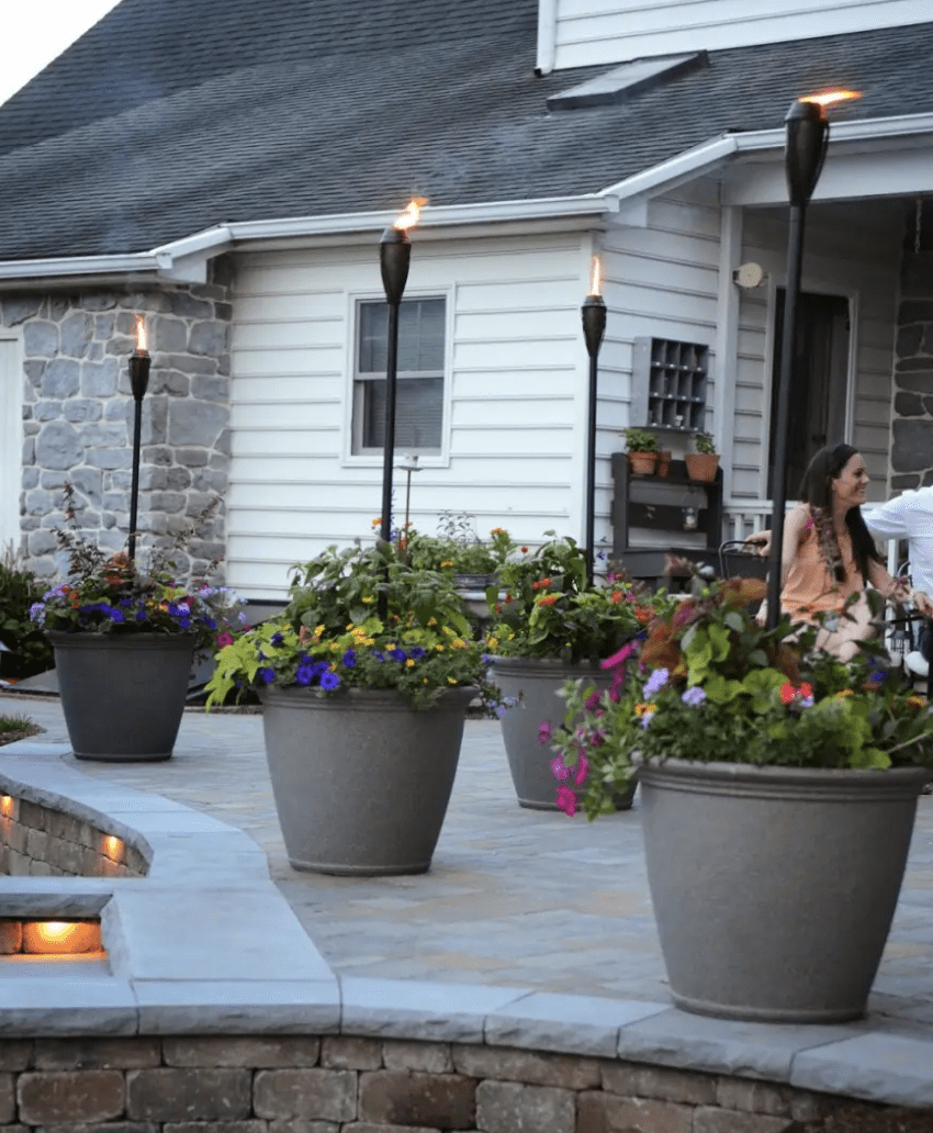 tiki torches in pots on patio backyard