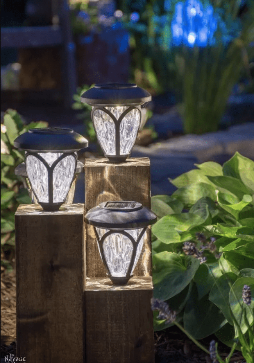 solar lights on wood blocks in garden at night