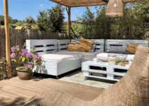 pallet furniture white on patio under sun shade with hanging pendant