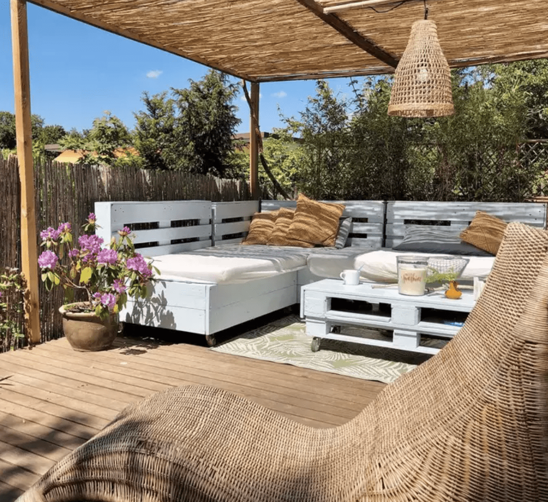 pallet furniture white on patio under sun shade with hanging pendant