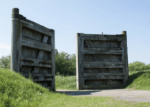 large oversized wooden gates leading out into green space