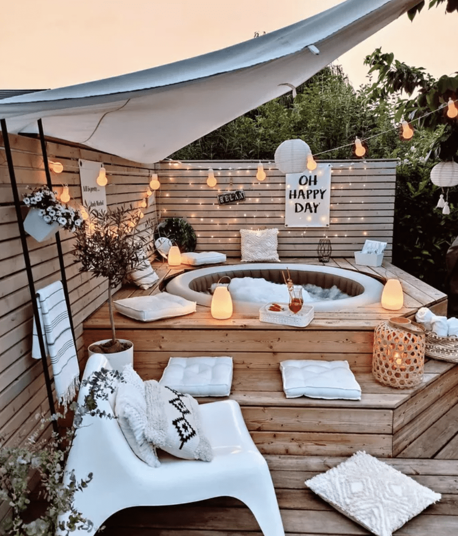 inflatable pool with deck built around it white umbrella pillows cushions