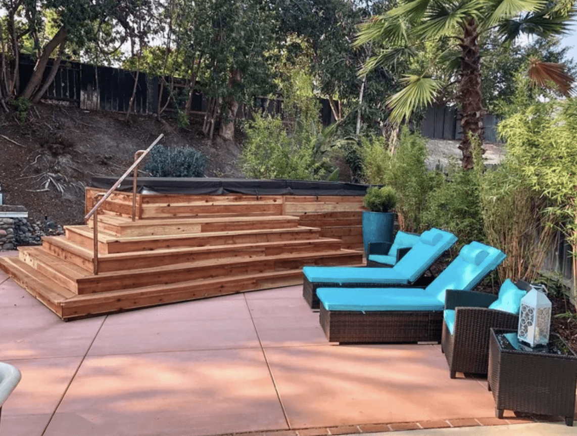 modern deck with above ground pool and two blue cushion pool lounger chairs