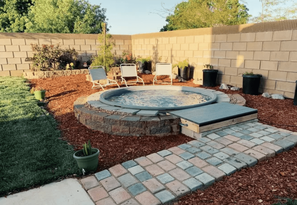 above ground pool surrounded by brick pavers