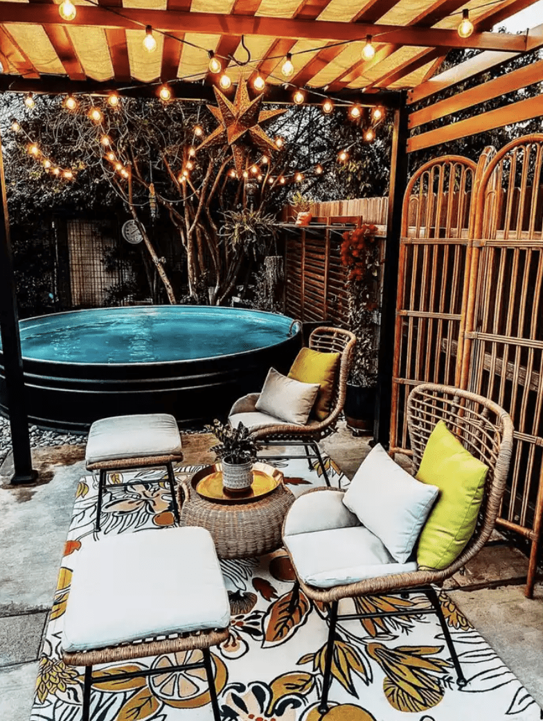 black stock tank pool with seating area and pergola