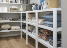 white short basement shelving with pillows and blankets on it