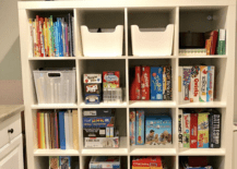 cube storage in basement with board games and books
