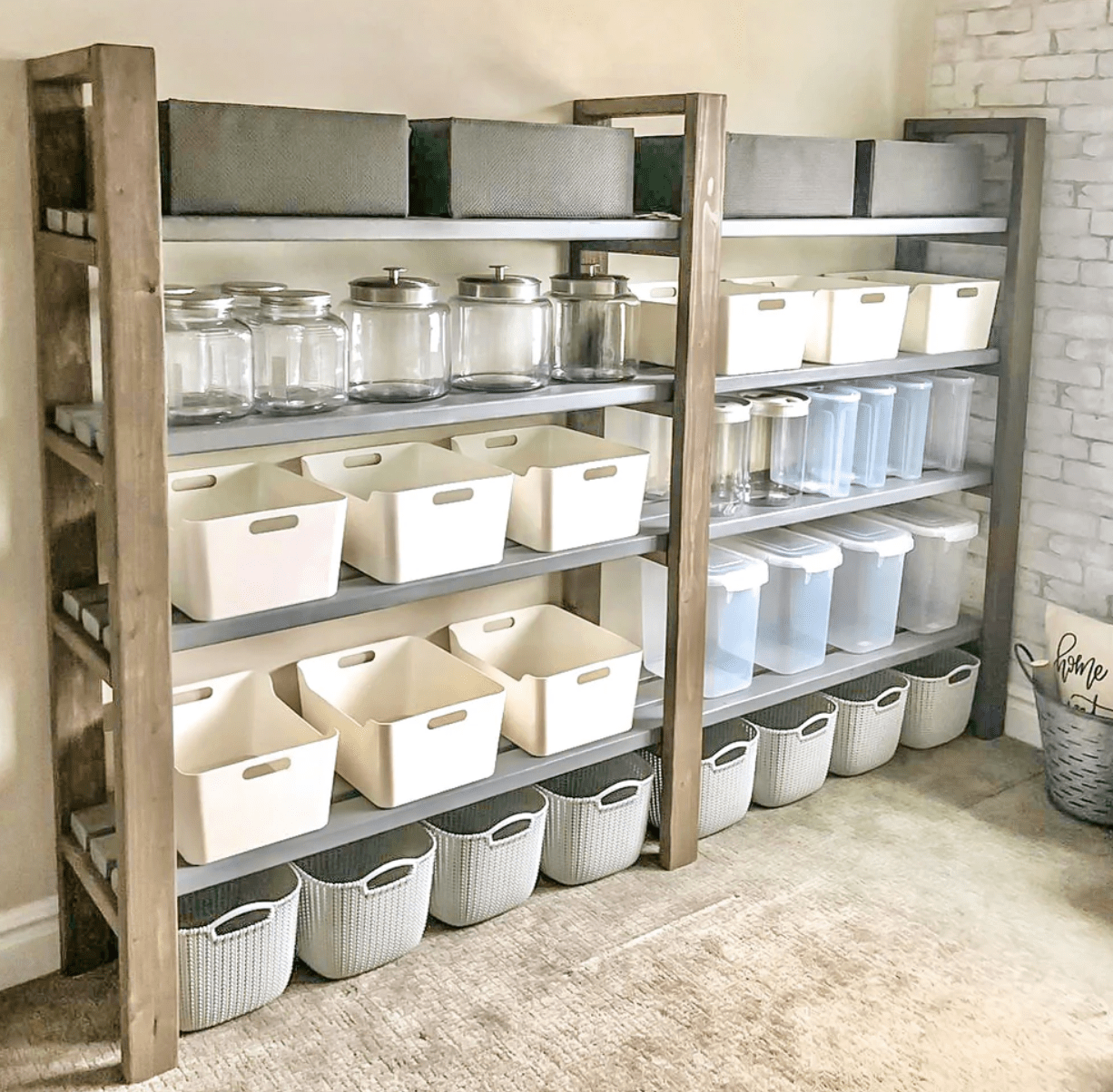 open pantry in basement with white plastic totes and jars