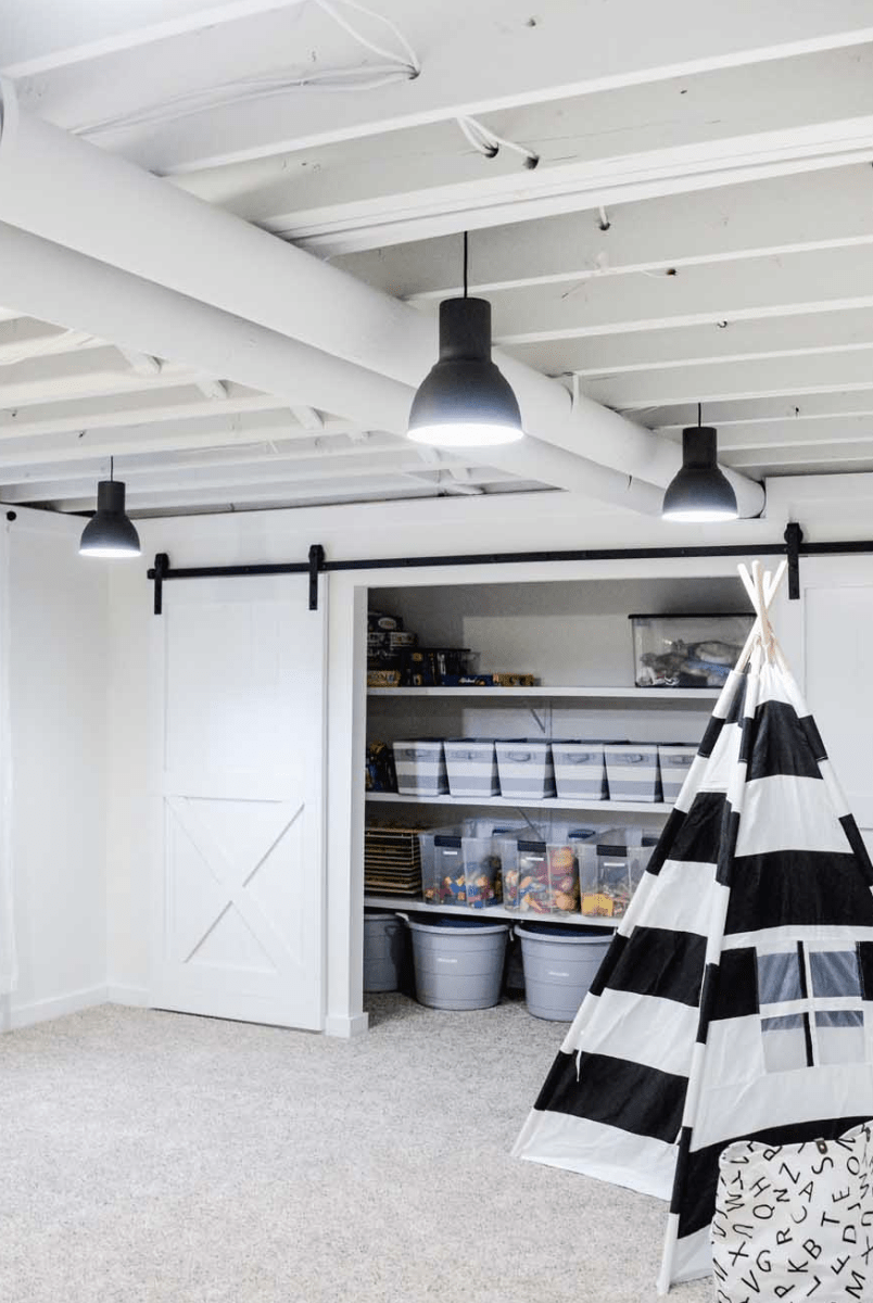 basement with exposed ceiling black and white striped teepee