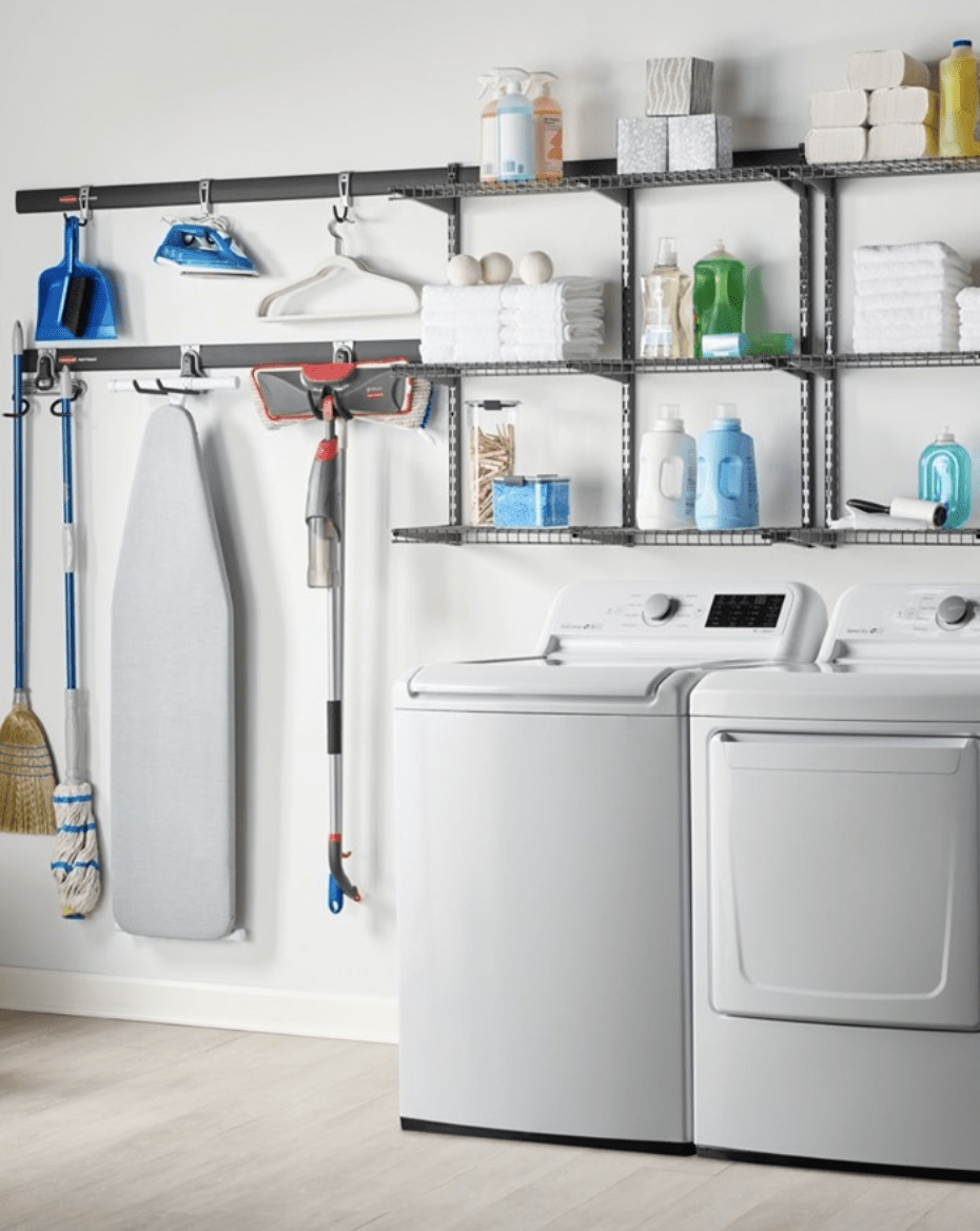 laundry room in basement with hanging rubbermaid shelving unit