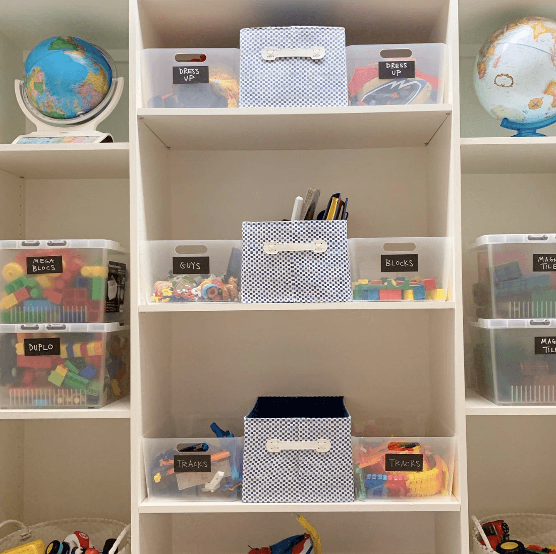 white shelving unit in basement with kids toys and labeled totes