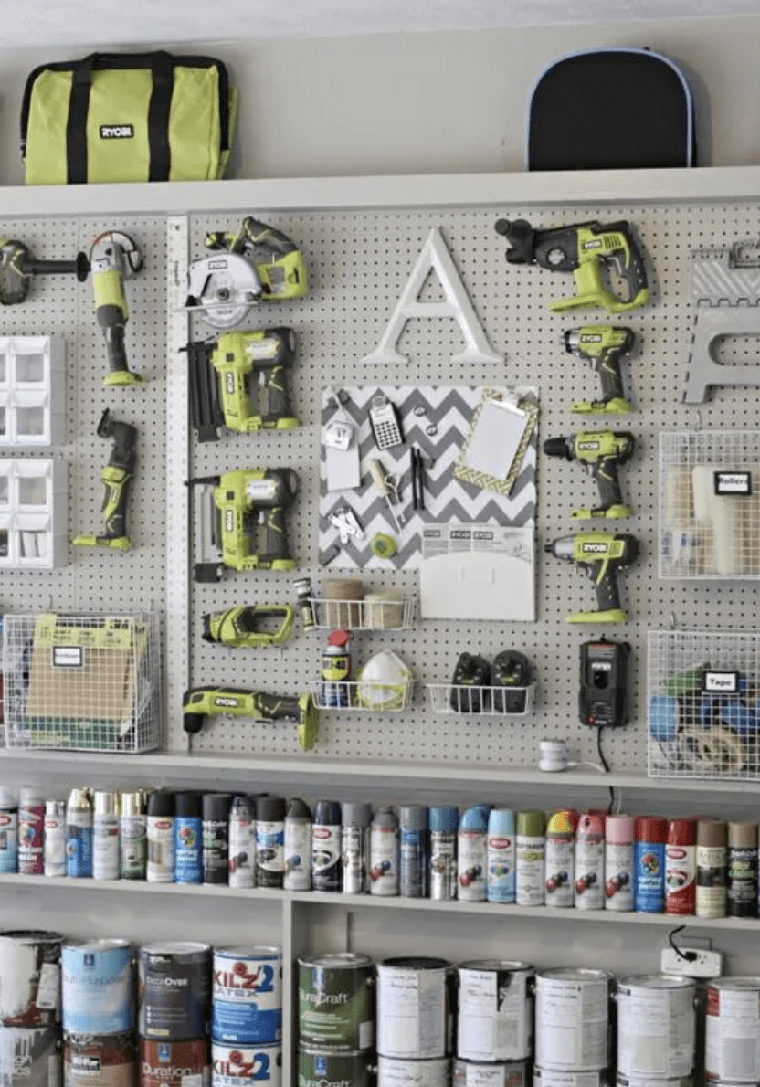 grey pegboard with ryobi power tools on wall