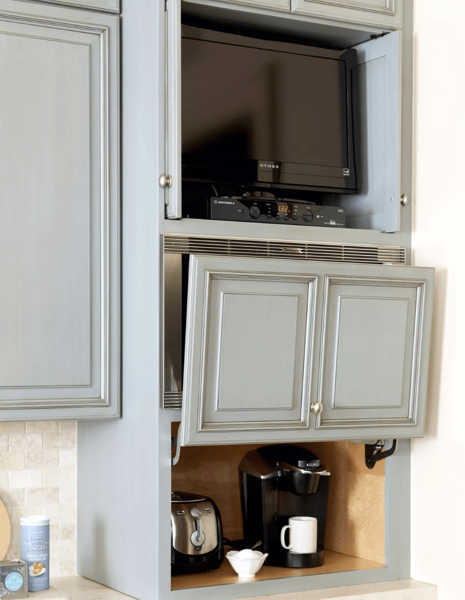 blue kitchen cabinetry with appliance garage coffee maker and tv toaster inside