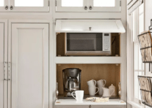 kitchen cabinetry with appliance storage grey with glass doors microwave