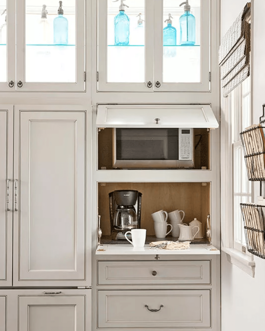 kitchen cabinetry with appliance storage grey with glass doors microwave