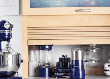 roll up wood cupboard in kitchen with blue appliances