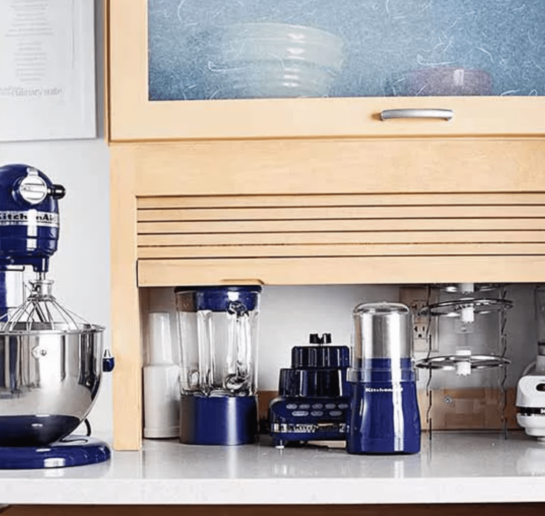 roll up wood cupboard in kitchen with blue appliances