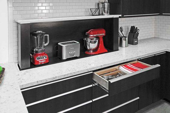 storage lift in kitchen cupboard black with red appliances