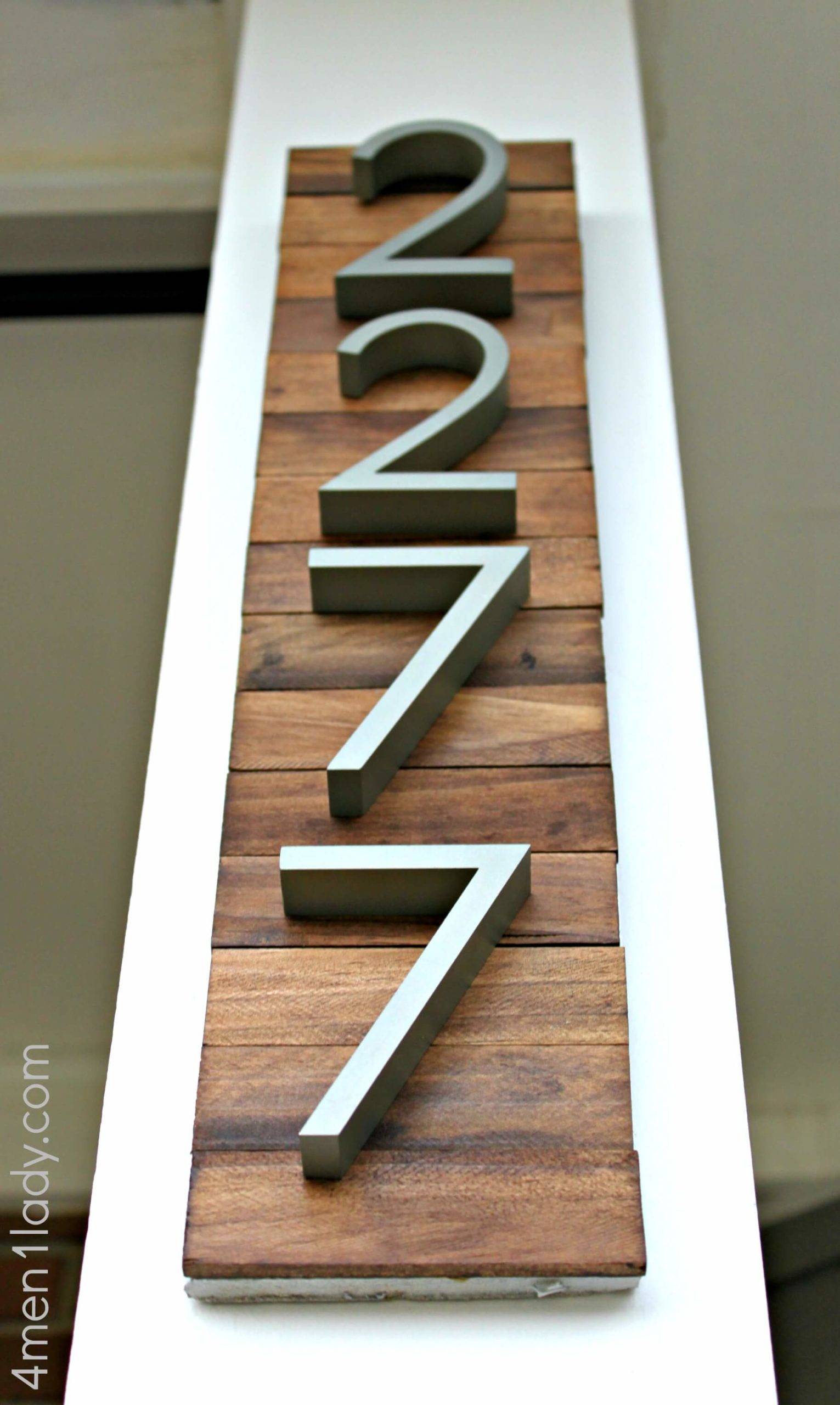 vertical wood sign with house numbers close up