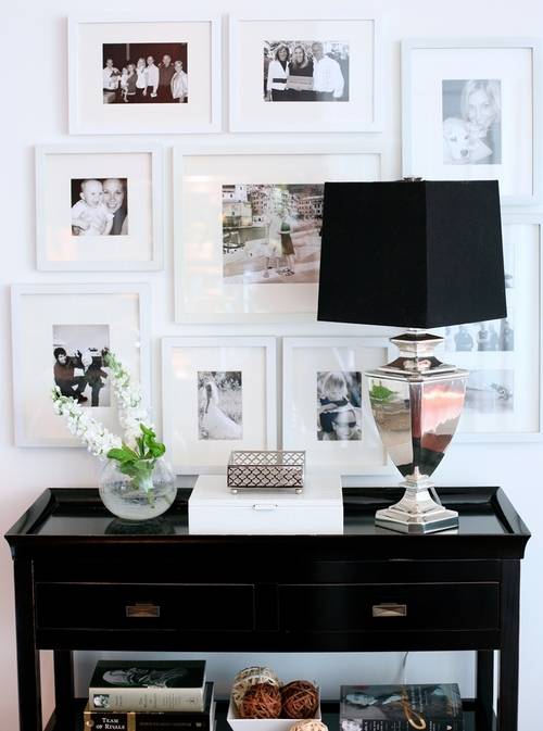 Black & white photo wall gallery, mirrored lamp with black shade, glossy white lacquer box and Bailey Street glossy black Tamara hall console table.