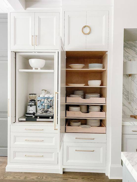 White kItchen with a small appliances cabinet fitted with folding doors.