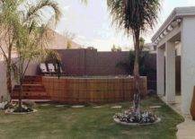 wood framed pool on grass above ground palm tree