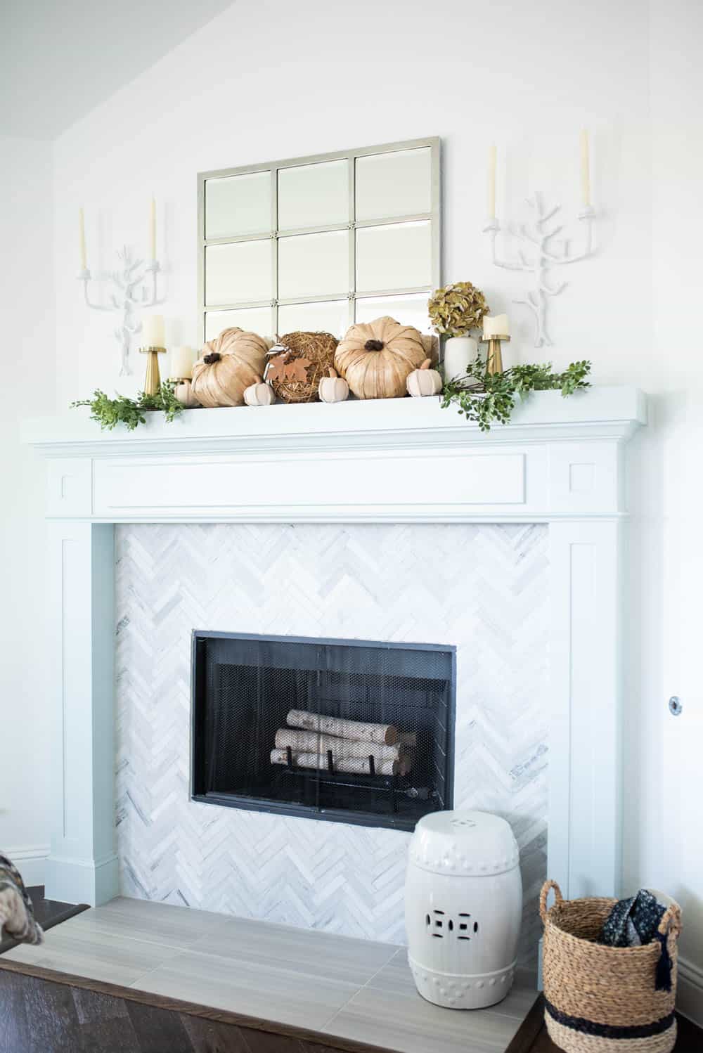 Elegant white fireplace mantel with fall decor.