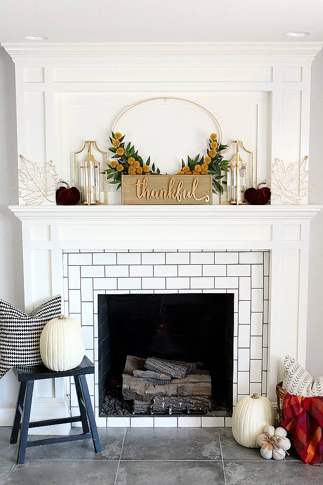 Contemporary fireplace mantel with touches of fall decor.