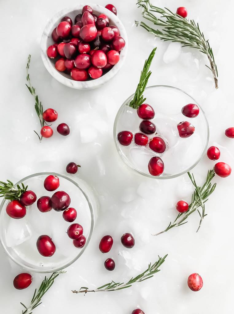 white cocktail with cranberries