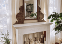 antique white fireplace with vintage mirror and full of candles