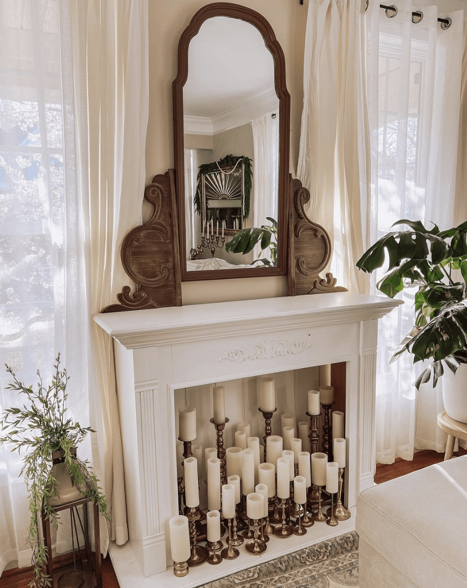 antique white fireplace with vintage mirror and full of candles