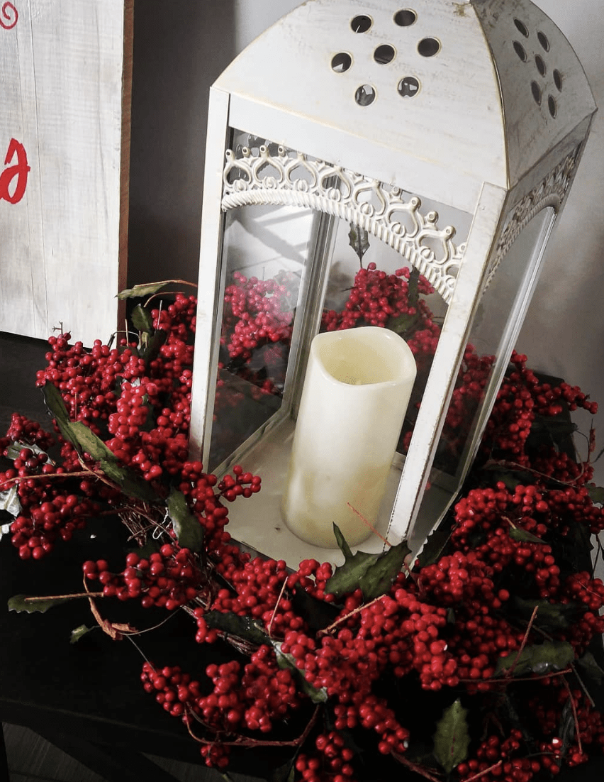 red berry wreath around a white lantern