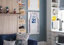 Basketball themed home office features framed jerseys on blue textured wallpaper and a blue couch on a white and blue rug.