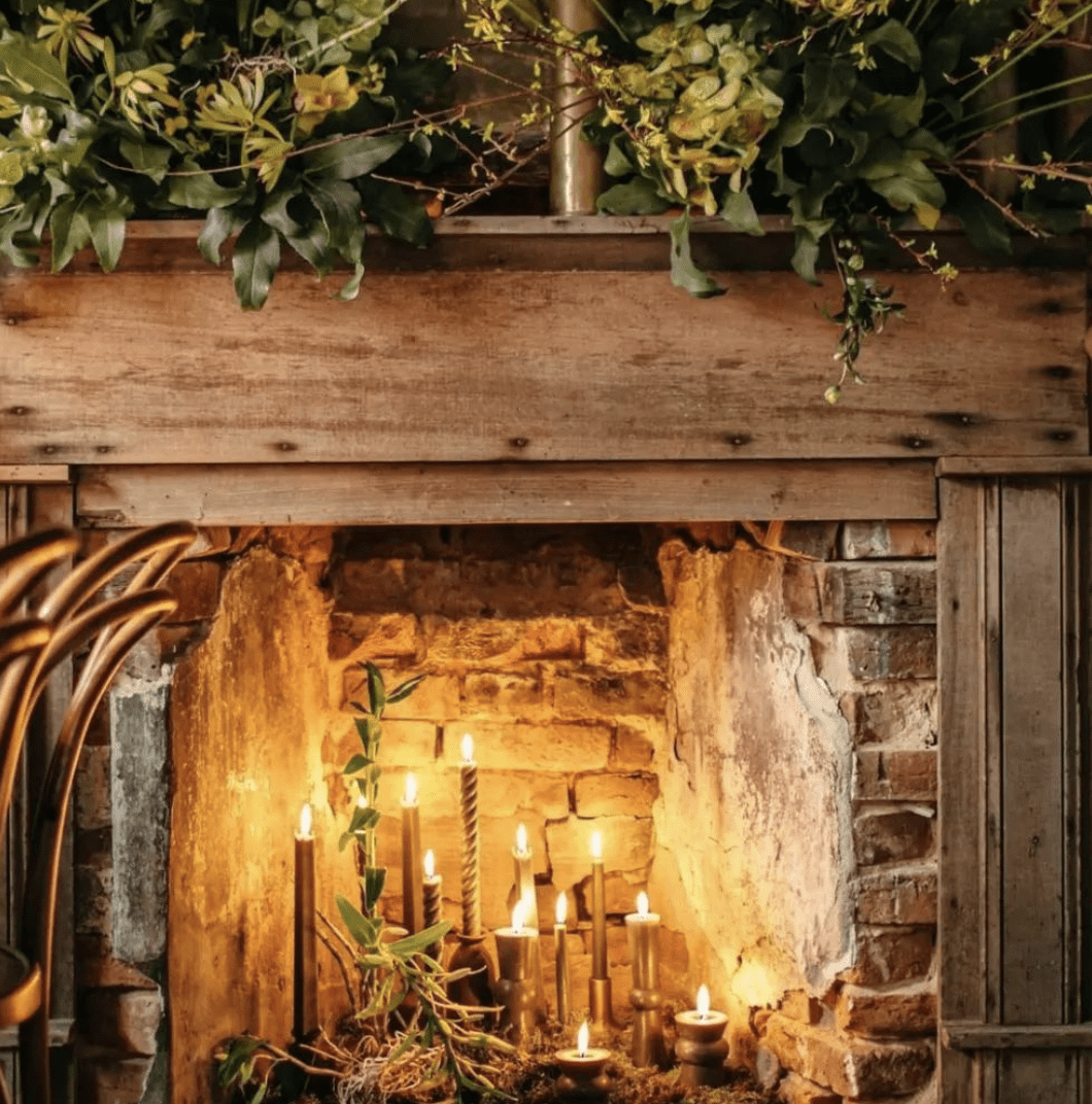 candlestick in fireplace brick with wood mantle and surround