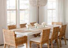 Elegant dining room features an ivory beaded chandelier that illuminates Serena & Lily balboa chairs at a Serena & Lily terrace dining table atop a tan rug and cream curtains.