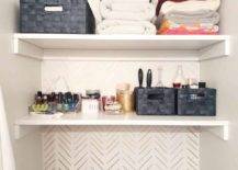 closet shelves in bathroom with folded towels and storage containers