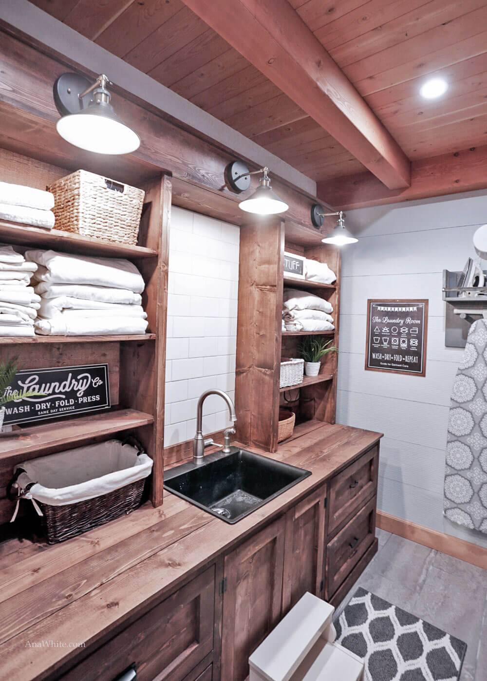 wood wall plank ceiling laundry room hanging barn light wash sink folded towels in cupboard