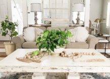 white country chic living room with large wood rustic coffee table white beige sofa hanging distressed rustic window chandelier white pillars wooden beaded decor accents