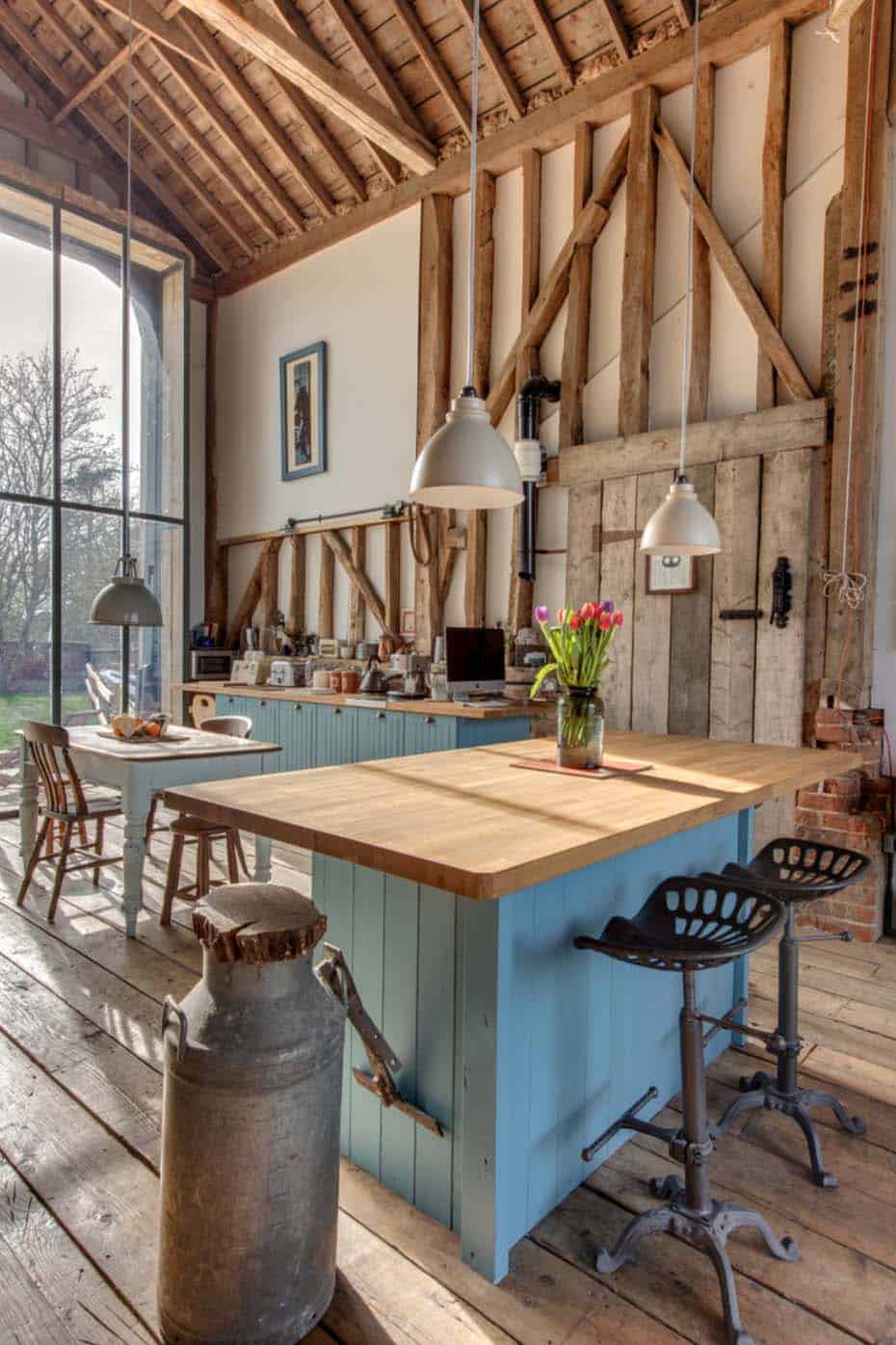 country barn kitchen with exposed beams island tractor seat stools hanging pendants