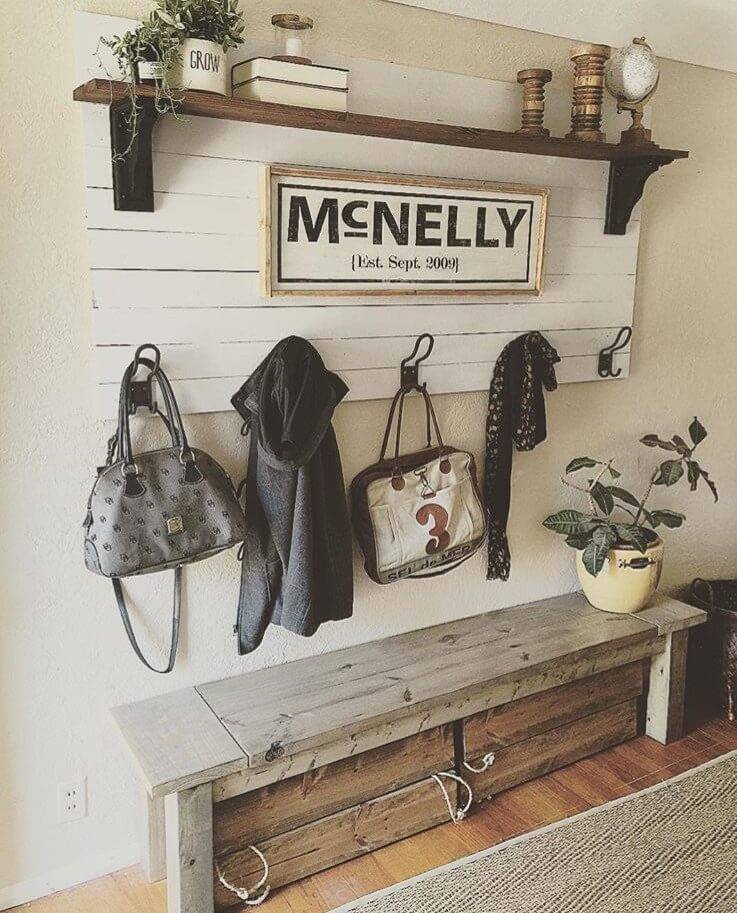 farmhouse country chic entry way pallet sign wood shelf old wood bench hanging jackets and greenery