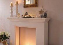 a faux fireplace with white pillar candles, neutral ornaments and stars for creating a Christmas ambience