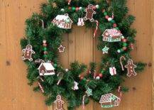 evergreen wreath covered with gingerbread men houses and candy canes