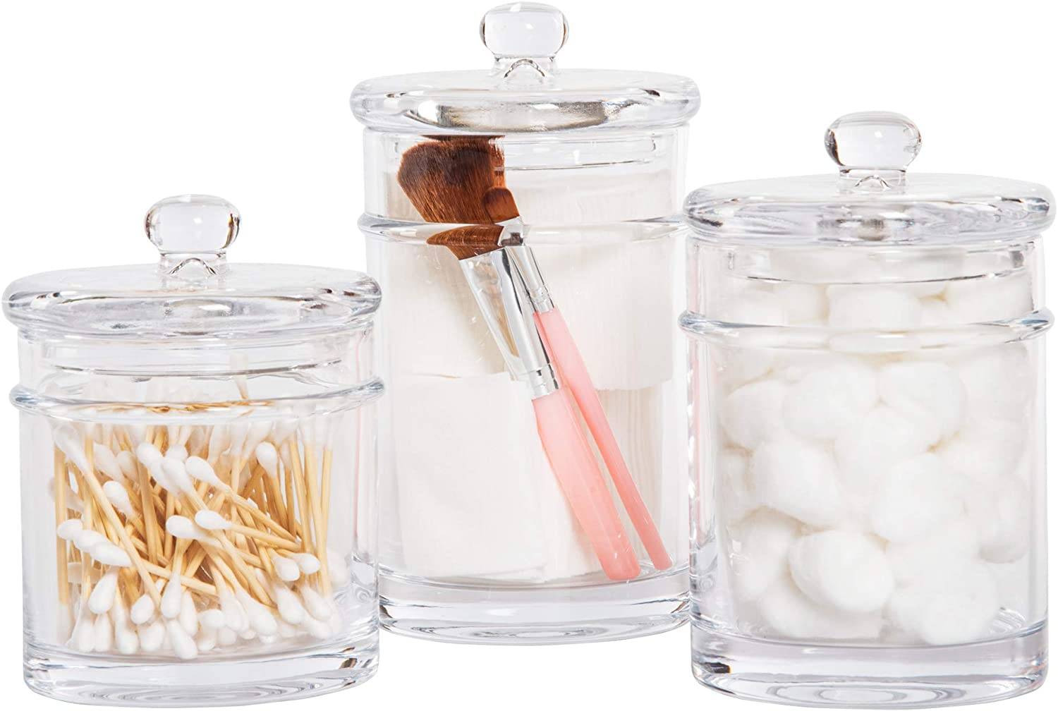 product photo of glass apothecary jars with cotton swabs cotton balls makeup brushes
