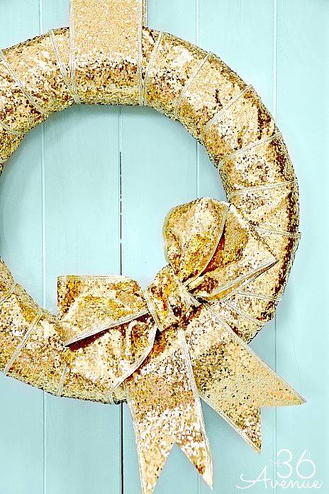 glitter ribbon wrapped around wreath form on blue background