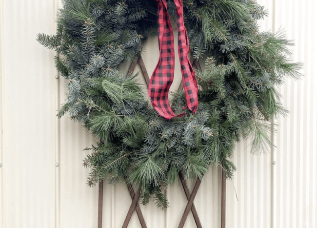 evergreen wreath with black and red plaid ribbon