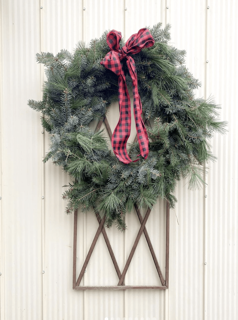 evergreen wreath with black and red plaid ribbon