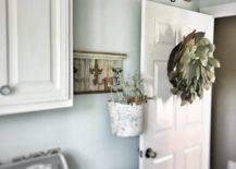 ladder hanging from ceiling in laundry room magnolia wreath hanging on door washer and laundry basket
